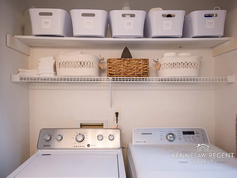 This clean and updated laundry space is a convenient and functional space.There is ample storage for laundry supplies.