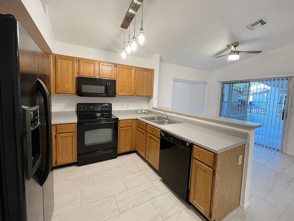 Kitchen and dining area looking out to patio and greenbelt.