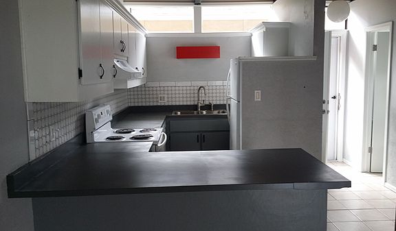 Kitchen and front door from living area