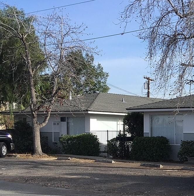 Front view of ground level two bedroom with two off street parking stalls and private patio off kitchen