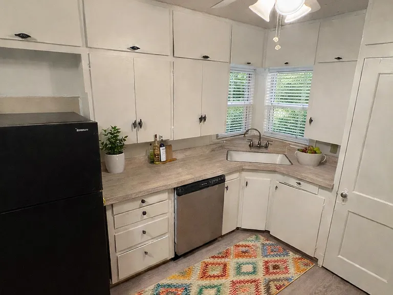 Large kitchen with space for breakfast table and lots of cabinets for storage