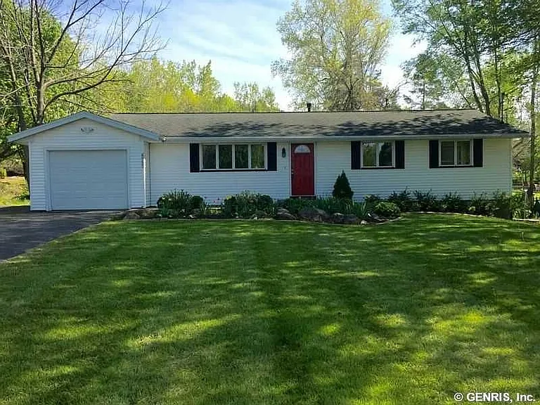 Front view. Garage door opener. Exterior motion lighting.