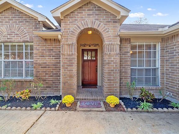 Beautiful front door with curb appeal landscaping and full gutters