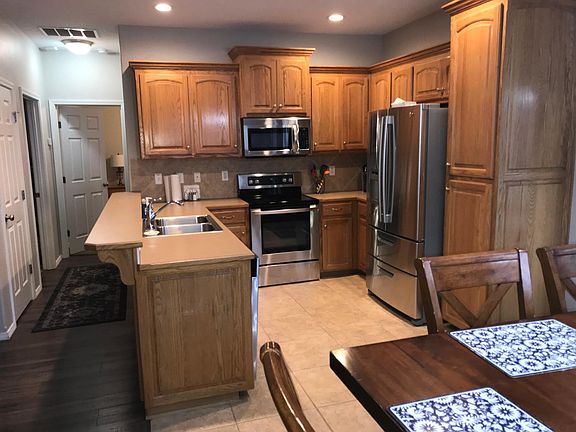 Kitchen with electric flat surface oven, dishwasher, disposal, microwave and refrigerator