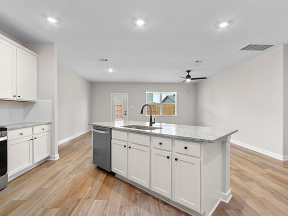 Both the kitchen and dining room overlook the spacious backyard.