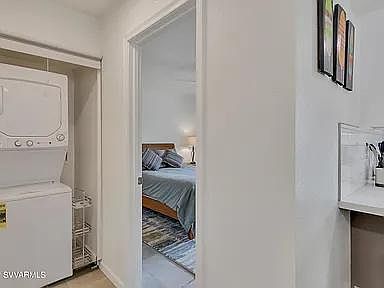 Washer and dryer in unit. Entrance to bedroom. A brand new bed, bed frame with storage, walk-in closet and chest. Sheets provided.