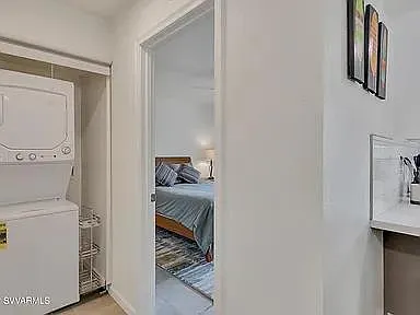 Washer and dryer in unit. Entrance to bedroom. A brand new bed, bed frame with storage, walk-in closet and chest. Sheets provided.