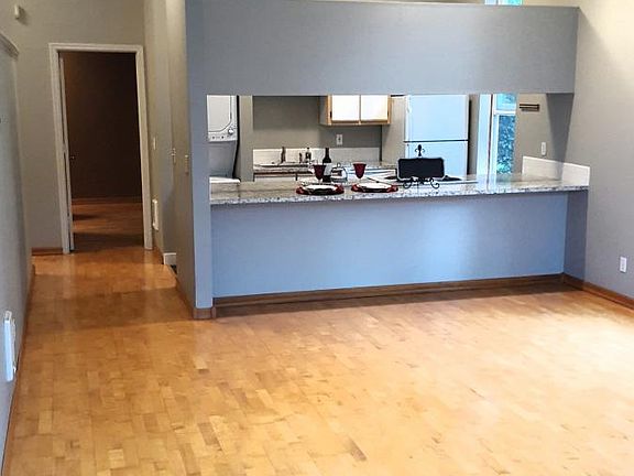 living room to kitchen w/ 12 ft ceilings throughout