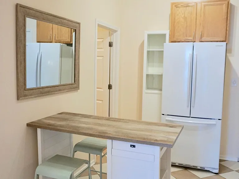 Eat in kitchen with (removable) peninsula and barstools. It has additional storage. This can stay in the apartment for your convenience, or be removed for your table/chairs.