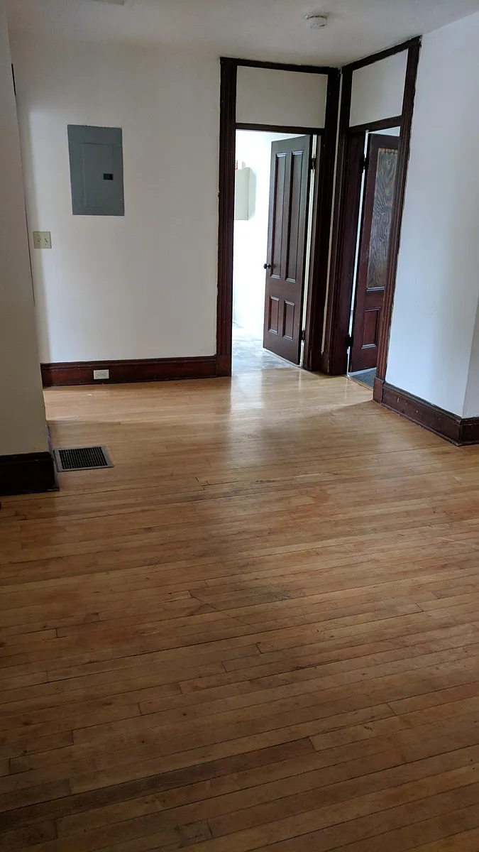 Living room with entrance to the bathroom straight ahead and bedroom to the right - 42 Grant St #2