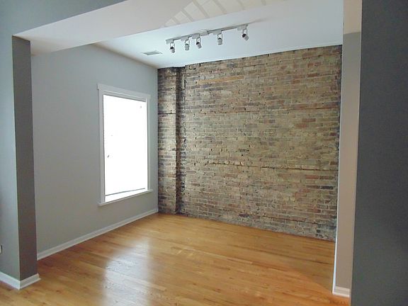 Dining Room With Exposed Brick, Bay Windows With Blinds, Har