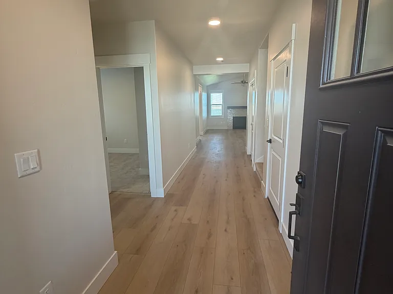 As you enter the home, you'll be welcomed by a charming and spacious entryway that provides a warm, inviting first impression and a comfortable transition into the heart of the home.