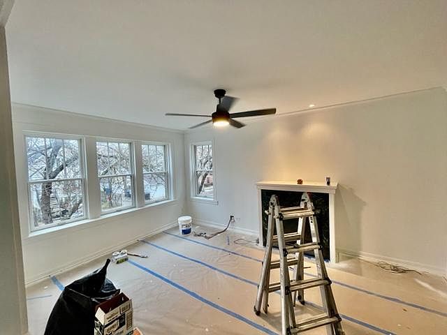 Formal Living Room with working fireplace, tons of natural light and high ceilings.