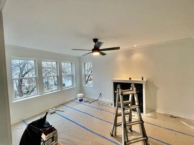 Formal Living Room with working fireplace, tons of natural light and high ceilings.