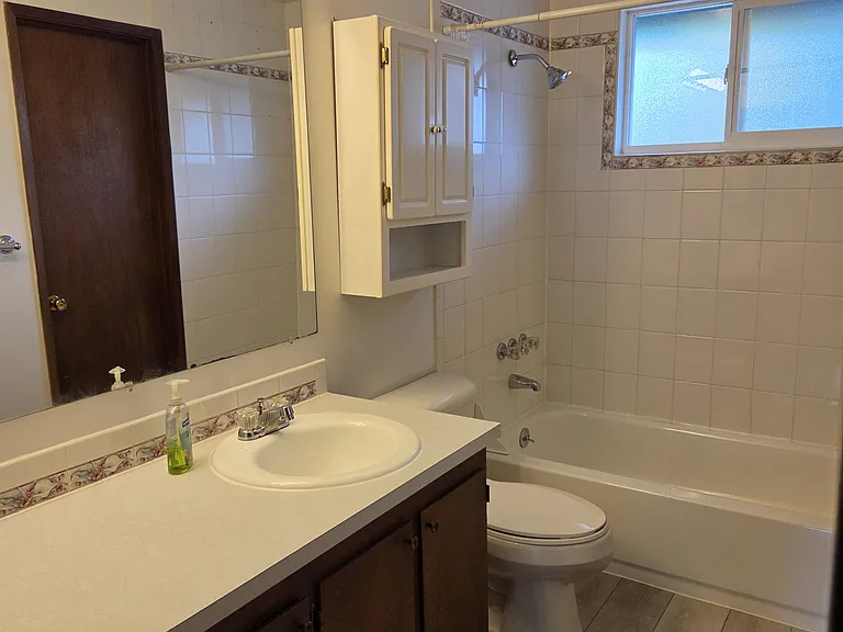 Bathroom with newer flooring and toilet
