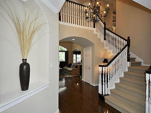 Ceiling expands to 20 ft going into the living room & upstairs area.  Single turn stairway for ease & safety!