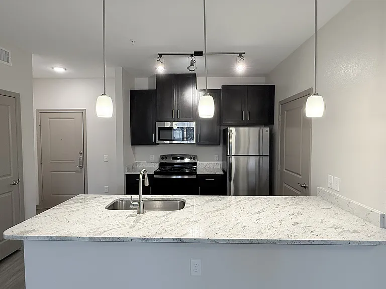 Kitchen with Granite Countertops and Brown Cabinets