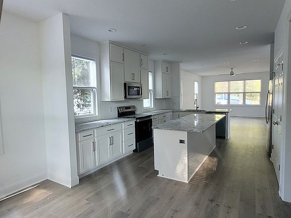 View from the eat-in area through the kitchen to the main living area