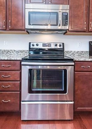 Cooking Center with smooth top range and micro hood in stainless steel.