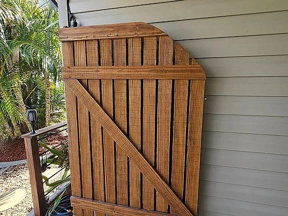 Outside shower hidden by tasteful wooden door