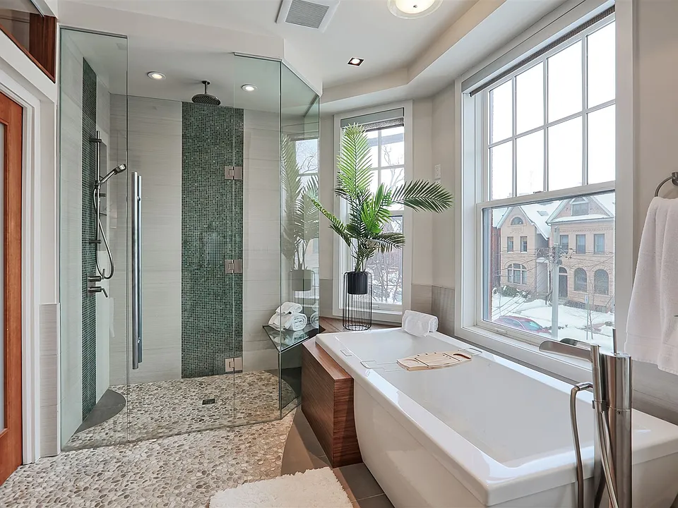 primary bathroom with walk in closest, shower, tub...