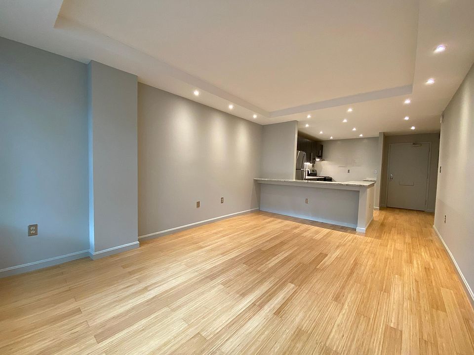 Large living room with recessed LED lights, eco-friendly bamboo floor, and fully cable ready.