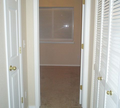 Hallway to first room with closet on the left and Furnace an