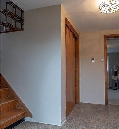 This is the entry view as you walk in the door.  Steps to the left head to the living room.  Door straight ahead leads to the la