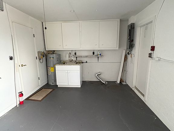 Garage with new sink & lots of storage Also has garage door opener