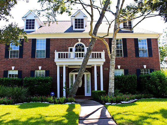 Beautiful exterior with large trees.