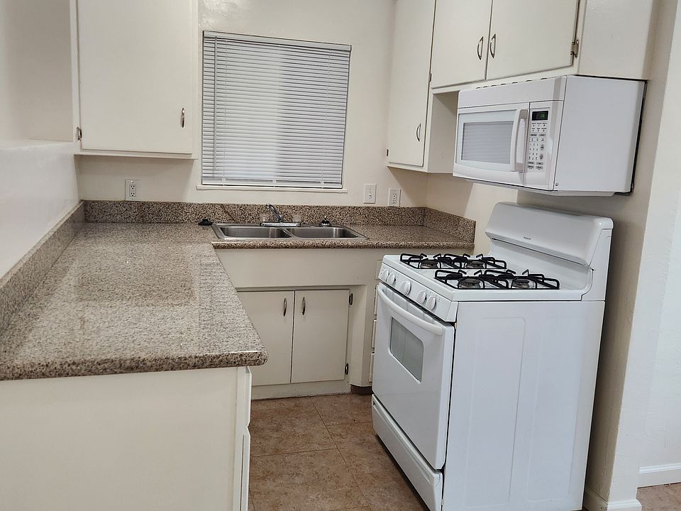 Kitchen with granite countertops, gas range and dishwasher
