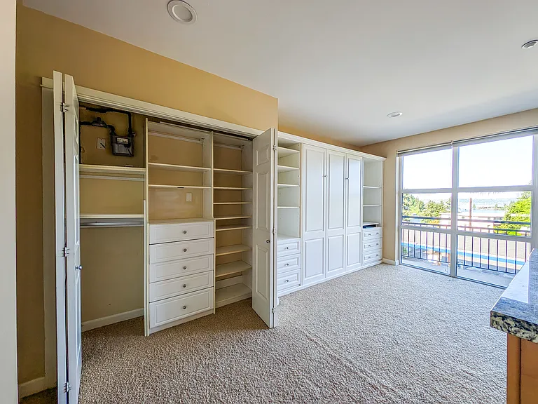 Large closet with built in shelves and drawers
