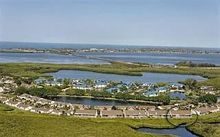 Aerial view of Perico Bay Club. This condo is in the blue roofs, overlooking the lagoon, and then Palma Sola Bay. See the Palma Sola Causeway? When the bridge goes up for boats to pass under, the very top of the bridge can be seen from the condo screene