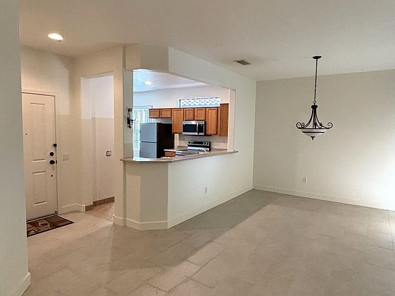 Living room, view toward front door and kitchen.