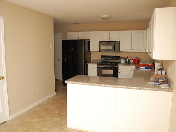 Kitchen with newer appliances and open layout. Pantry seen