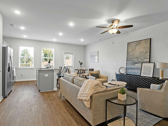 Bright and airy kitchen-living combo with large windows and modern finishes