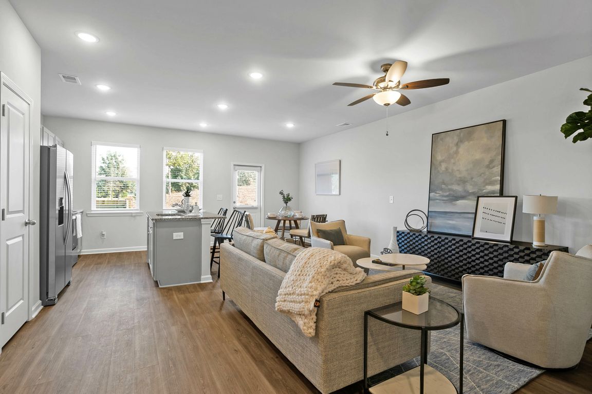 Bright and airy kitchen-living combo with large windows and modern finishes