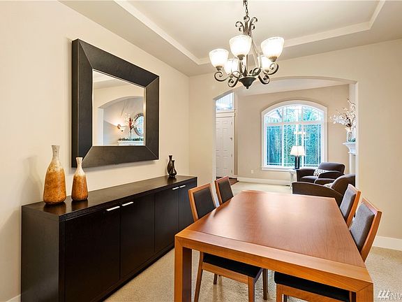 Formal dining room with kitchen behind and formal living just beyond next to the front door.