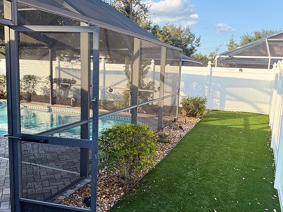 Dog turf is located on one side of the fenced yard.