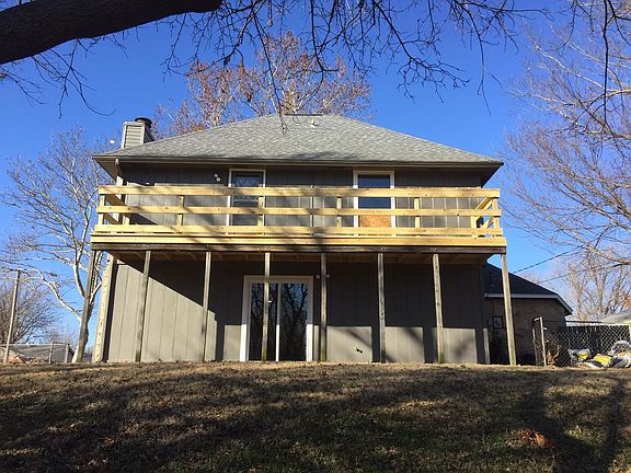 back of house with downstairs patio and upstairs balcony