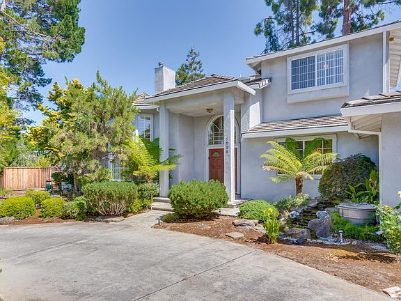 Bright and airy 3,385 square foot house featuring a welcoming, portico looking out to a lush front yard and fountain.