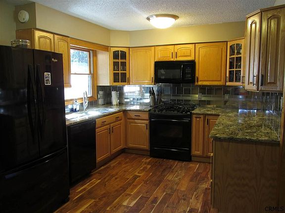 Granite counters, stainless steel tile back splash, wood floor