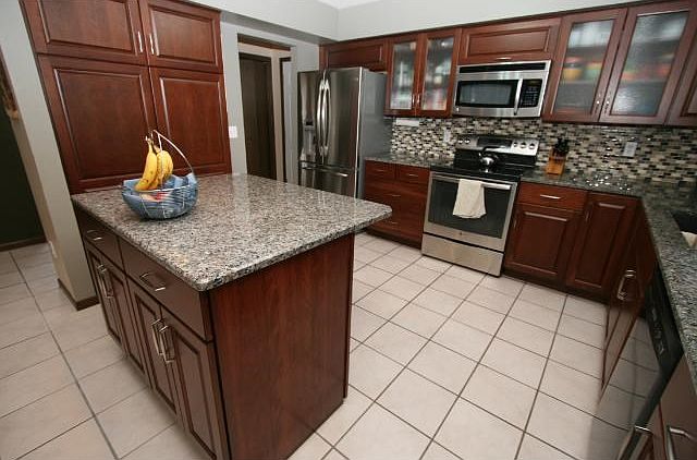 Absolutely exquisite kitchen with granite countertops, tile backsplash, stainless steel applncs, and center island!