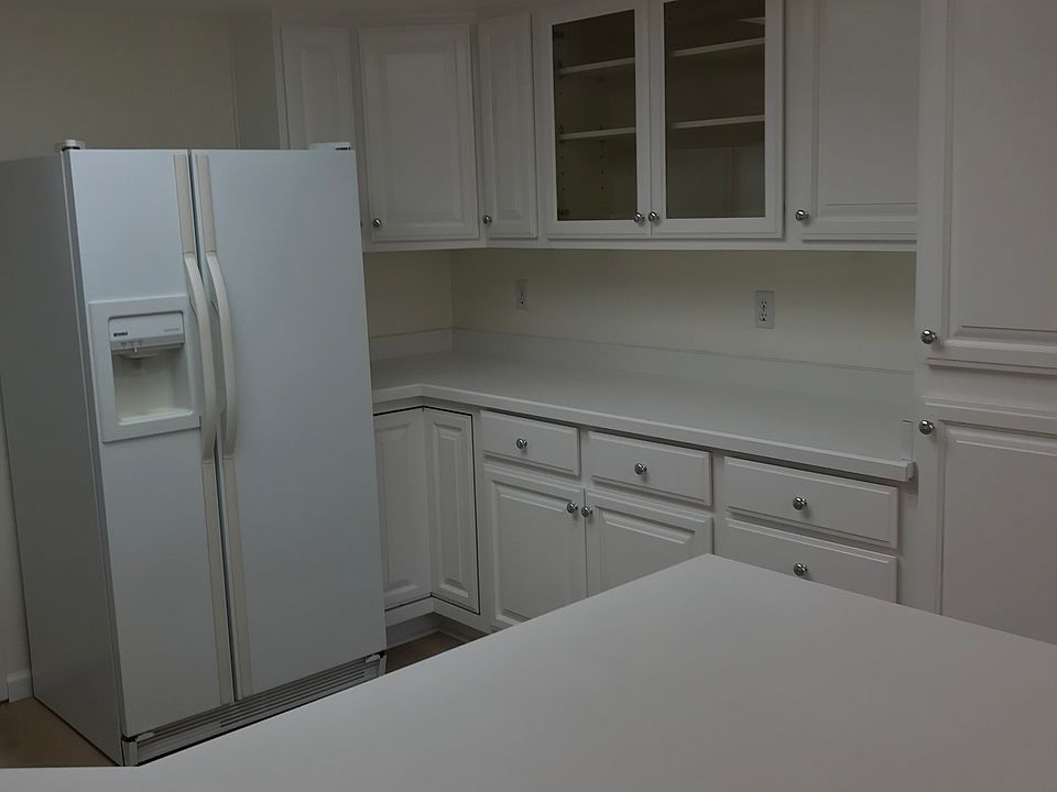 Kitchen with side by side refrigerator