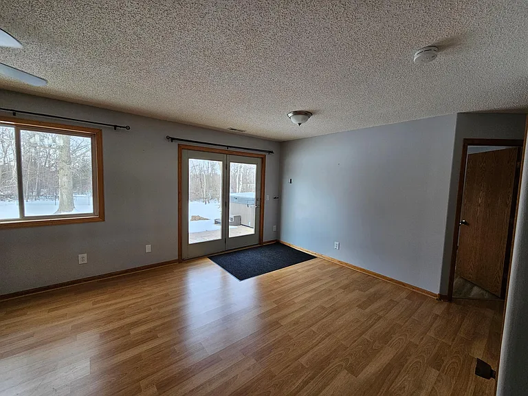 Lower level living area and door to patio and backyard