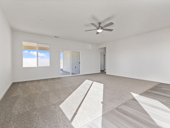 The family room is off of the kitchen and has a ceiling fan.