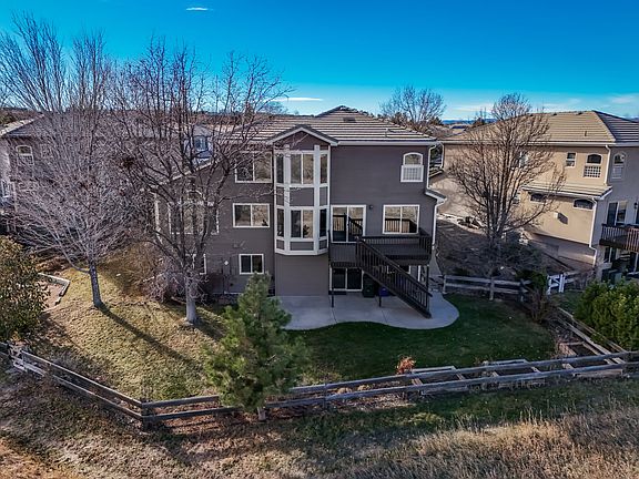 Private backyard backing to open space with rare privacy and views. Elevated deck and walk-out lower level create ideal indoor-outdoor living, while mature trees, fencing, and expansive windows enhance light, serenity, and everyday enjoyment.