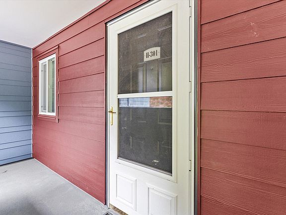 Covered entrance with screen door.