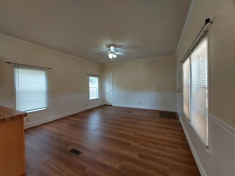 The Living Room is ~15' 4" x 14' 5". All brand new LVP flooring, first use! Lots of windows.