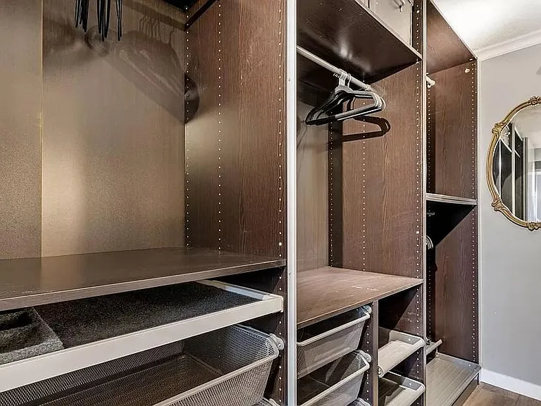Master bedroom custom closet has multiple storage systems